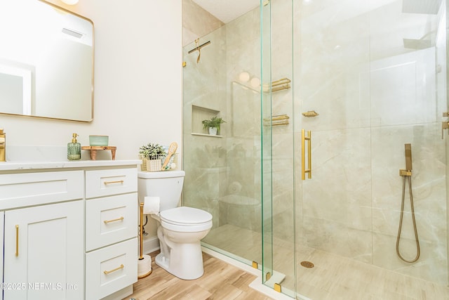 4282 Wolfe Dr, Macclenny, FL 32063 - full bathroom with a shower stall, toilet, vanity, and wood finished floors