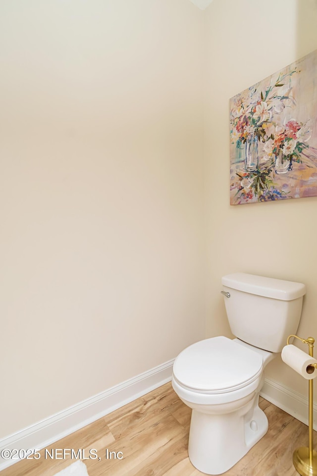4282 Wolfe Dr, Macclenny, FL 32063 - bathroom featuring baseboards, wood finished floors, and toilet