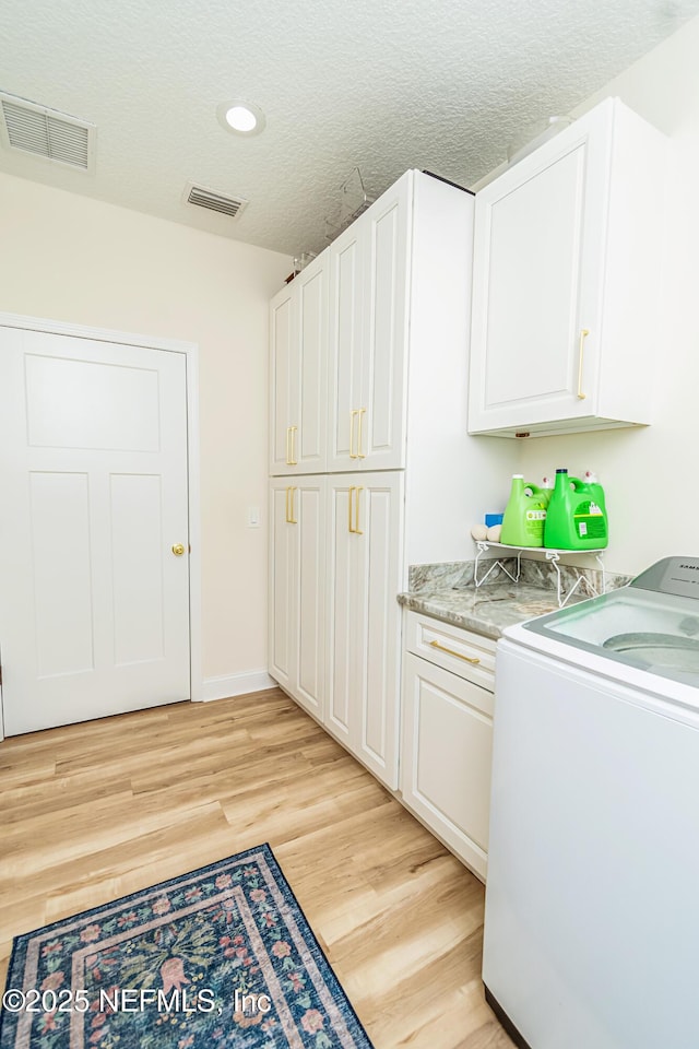 4282 Wolfe Dr, Macclenny, FL 32063 - washroom featuring washer / dryer, light wood-style flooring, cabinet space, a textured ceiling, and recessed lighting