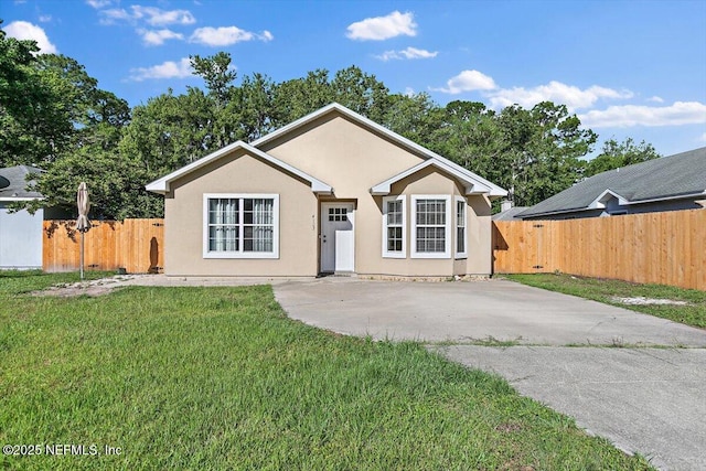 ranch-style home with stucco siding, concrete driveway, and a patio