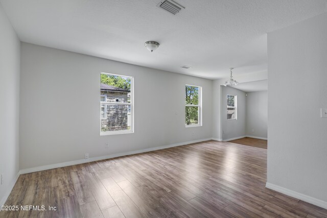 944 Bunker Hill Blvd, Jacksonville, FL 32208 - empty room with a chandelier, wood finished floors, and baseboards