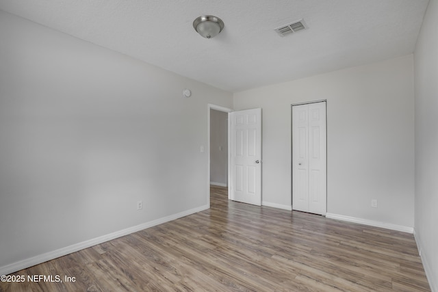 944 Bunker Hill Blvd, Jacksonville, FL 32208 - unfurnished bedroom with baseboards, wood finished floors, and a closet