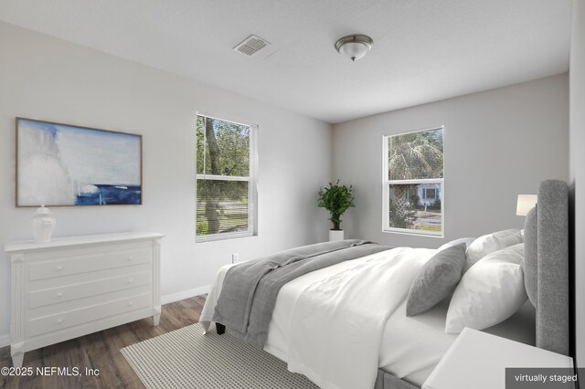 944 Bunker Hill Blvd, Jacksonville, FL 32208 - bedroom featuring multiple windows, dark wood-style floors, and baseboards