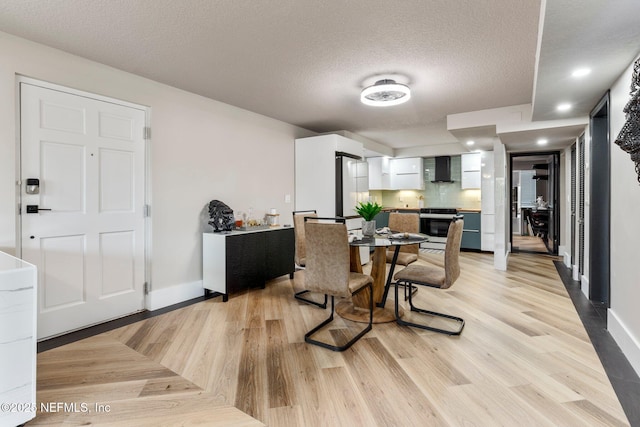 5375 Ortega Farms Blvd Unit 408, Jacksonville, FL 32210 - dining space with baseboards, light wood-type flooring, and a textured ceiling