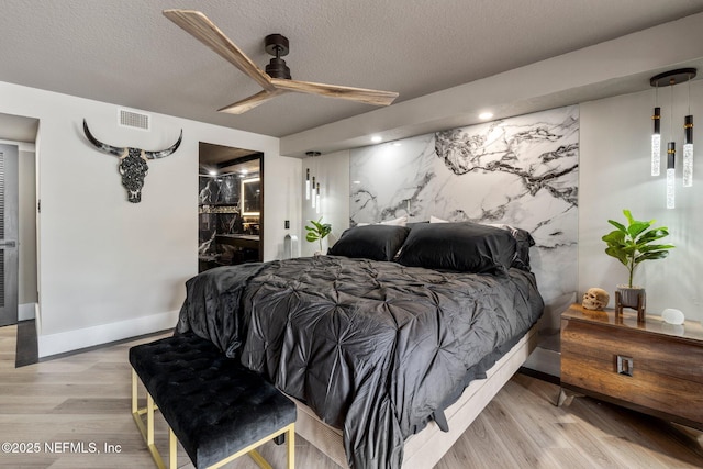 5375 Ortega Farms Blvd Unit 408, Jacksonville, FL 32210 - bedroom with baseboards, wood finished floors, a textured ceiling, and ceiling fan
