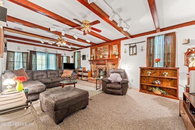 2995 Thunder Rd, Middleburg, FL 32068 - carpeted living room with ceiling fan, beam ceiling, track lighting, and a brick fireplace