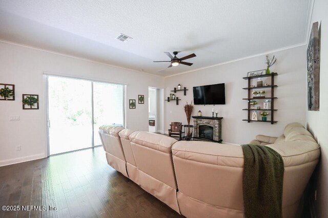 152 Cloverbrook Rd, Saint Johns, FL 32259 - living area featuring ceiling fan, dark wood-type flooring, ornamental molding, baseboards, and a stone fireplace