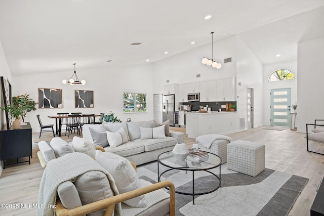 550 Robles Ln, Ponte Vedra Beach, FL 32082 - living area featuring a chandelier, light wood-type flooring, high vaulted ceiling, healthy amount of natural light, and recessed lighting