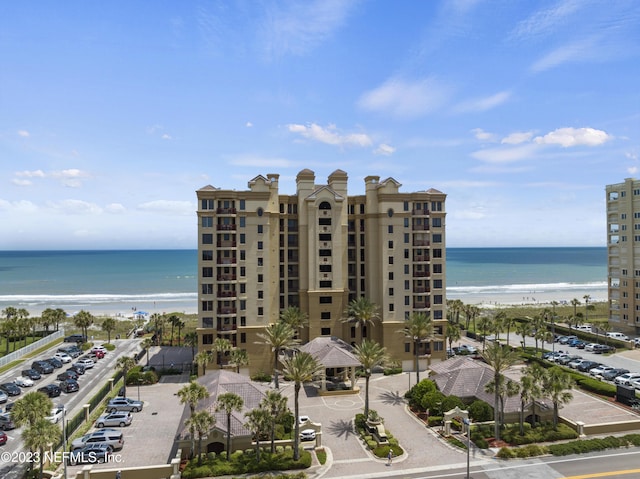 view of building exterior with view of water and beach