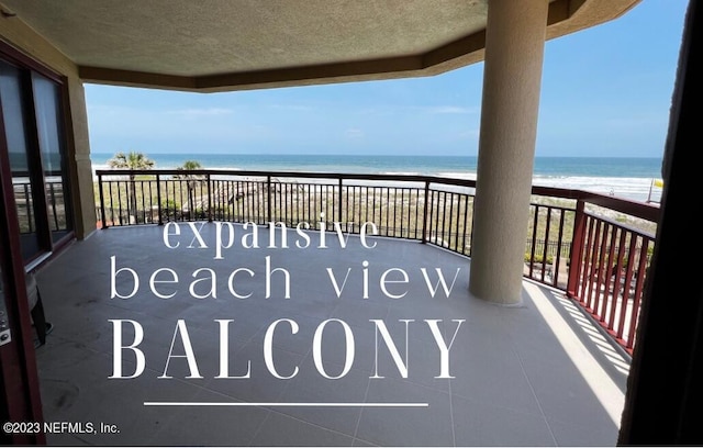balcony featuring view of water and beach