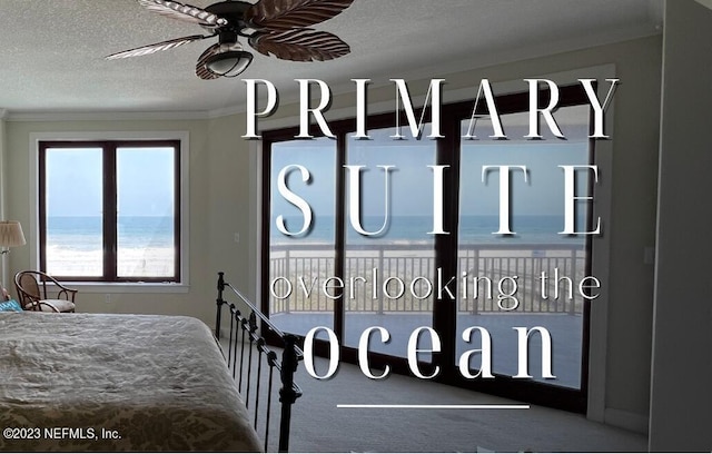 bedroom featuring carpet floors, a textured ceiling, crown molding, and a water view