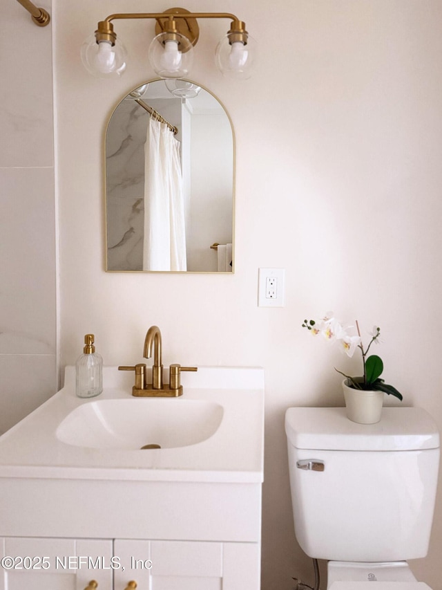 bathroom featuring vanity and toilet