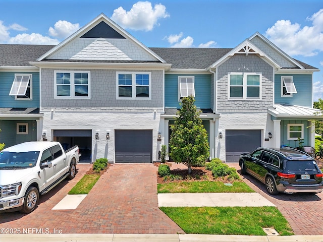 townhome / multi-family property featuring driveway and an attached garage