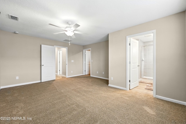 unfurnished bedroom featuring carpet, baseboards, ensuite bath, and a ceiling fan