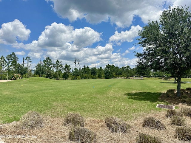 surrounding community featuring golf course view and view of scattered trees