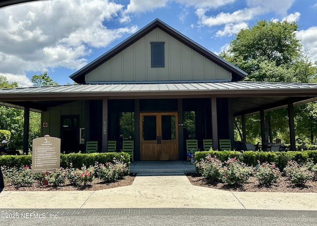 view of front facade featuring board and batten siding, a standing seam roof, and a porch