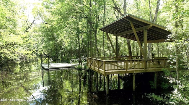 view of property's community featuring a view of trees and a deck