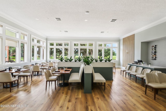 641 Thornwood Ln, Orange Park, FL 32073 - dining area featuring ornamental molding, a textured ceiling, and hardwood / wood-style floors