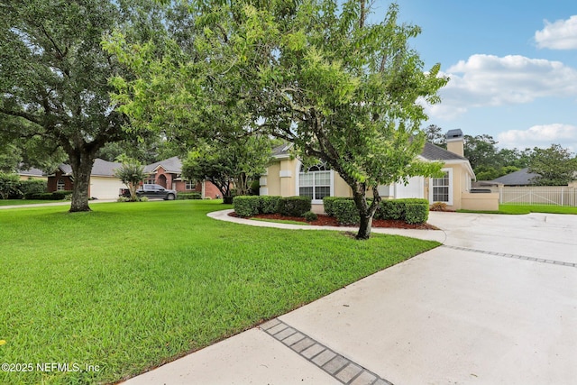 641 Thornwood Ln, Orange Park, FL 32073 - view of property hidden behind natural elements with a chimney, driveway, and stucco siding