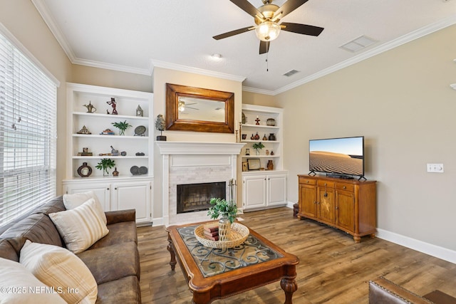 641 Thornwood Ln, Orange Park, FL 32073 - living area featuring a ceiling fan, light wood-style floors, a fireplace, crown molding, and baseboards