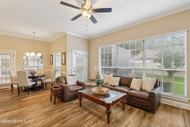 641 Thornwood Ln, Orange Park, FL 32073 - living room with light wood finished floors, plenty of natural light, ceiling fan, crown molding, and a chandelier