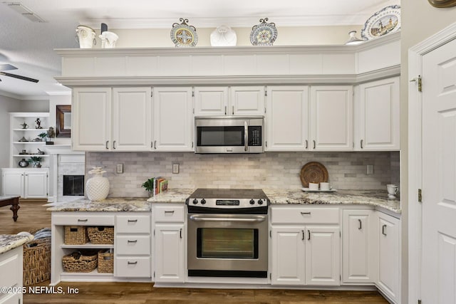 641 Thornwood Ln, Orange Park, FL 32073 - kitchen with appliances with stainless steel finishes, ornamental molding, white cabinetry, a ceiling fan, and wood finished floors