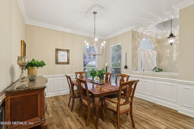 641 Thornwood Ln, Orange Park, FL 32073 - dining area featuring wood finished floors, a chandelier, a decorative wall, a wainscoted wall, and ornamental molding