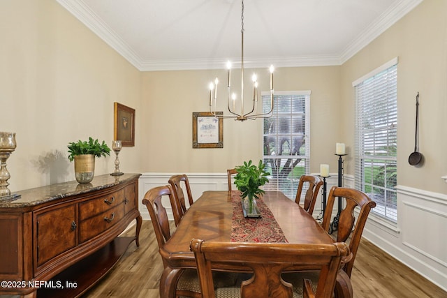 641 Thornwood Ln, Orange Park, FL 32073 - dining space featuring a chandelier, wood finished floors, ornamental molding, wainscoting, and a decorative wall