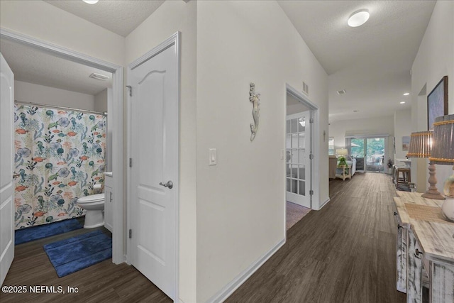 4101 Spring Creek Ln, Middleburg, FL 32068 - hallway with dark wood-type flooring, baseboards, and a textured ceiling