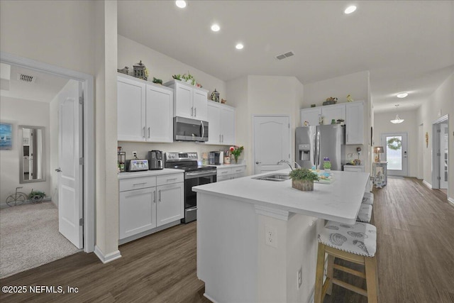 4101 Spring Creek Ln, Middleburg, FL 32068 - kitchen with stainless steel appliances, a sink, a kitchen island with sink, light countertops, and white cabinets