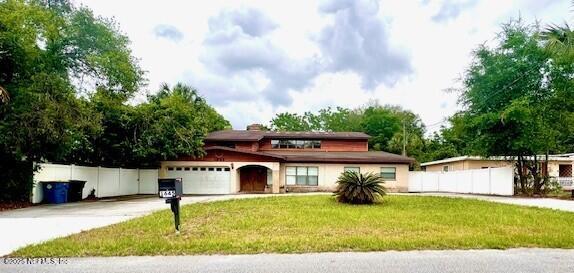 1645 Forest Hills Rd, Jacksonville, FL 32208 - view of front of house with concrete driveway and an attached garage
