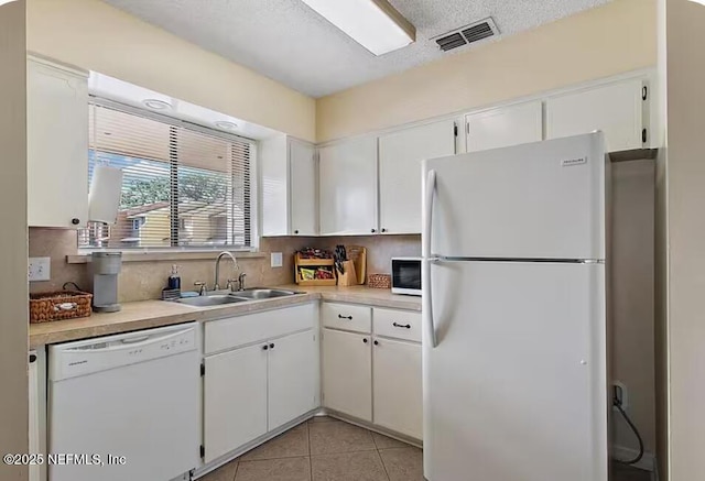 11523 Dunes Way Dr N, Jacksonville, FL 32225 - kitchen featuring white appliances, a sink, light countertops, white cabinets, and a textured ceiling