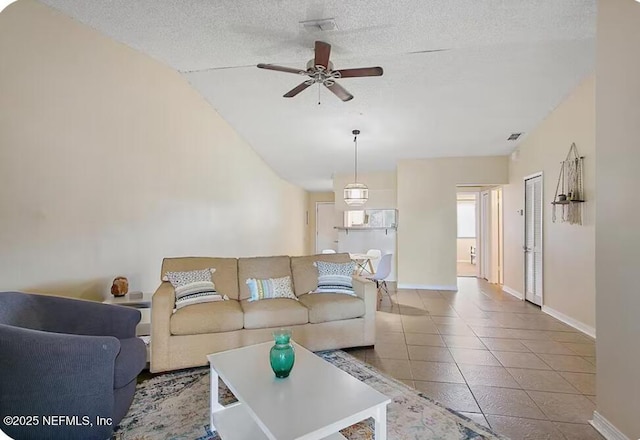 11523 Dunes Way Dr N, Jacksonville, FL 32225 - tiled living room featuring ceiling fan, baseboards, a textured ceiling, and vaulted ceiling