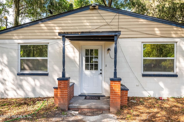 doorway to property with concrete block siding