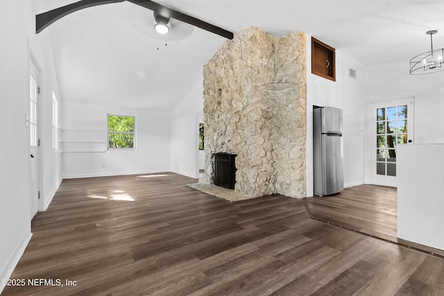 unfurnished living room featuring high vaulted ceiling, a stone fireplace, baseboards, a ceiling fan, and beamed ceiling