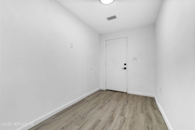 unfurnished room featuring light wood-type flooring and baseboards