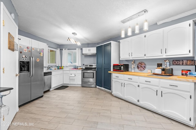 1167 Romaine Cir E, Jacksonville, FL 32225 - kitchen with appliances with stainless steel finishes, white cabinets, a textured ceiling, wood counters, and a sink