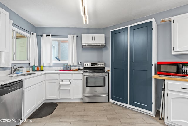 1167 Romaine Cir E, Jacksonville, FL 32225 - kitchen featuring appliances with stainless steel finishes, a sink, white cabinets, light countertops, and wood finish floors