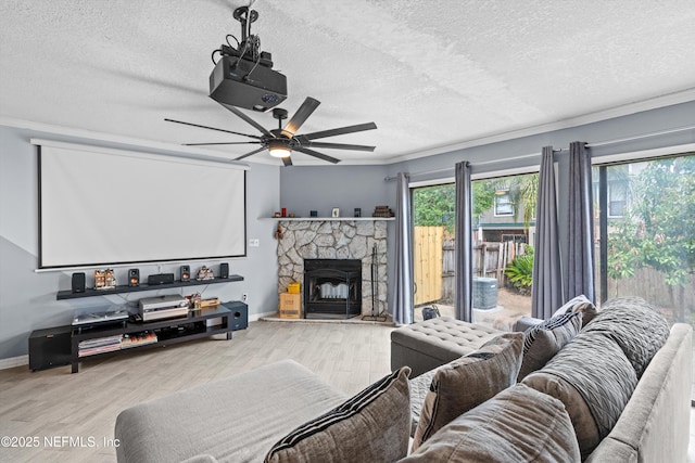 1167 Romaine Cir E, Jacksonville, FL 32225 - living room with a textured ceiling, wood finished floors, ceiling fan, baseboards, and a fireplace