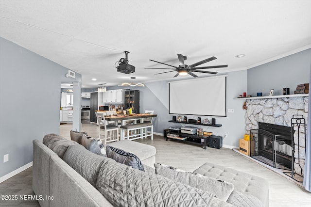 1167 Romaine Cir E, Jacksonville, FL 32225 - living room with baseboards, a ceiling fan, light wood-style floors, a stone fireplace, and recessed lighting