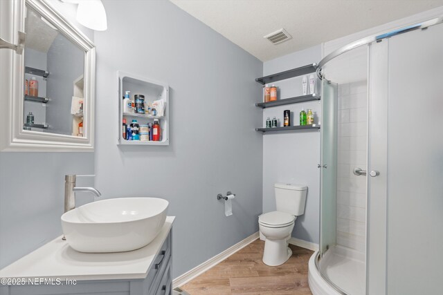 1167 Romaine Cir E, Jacksonville, FL 32225 - full bath with wood finished floors, a stall shower, toilet, and vanity