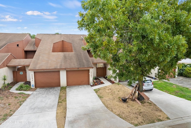 1167 Romaine Cir E, Jacksonville, FL 32225 - view of front facade with a shingled roof, driveway, stucco siding, and an attached garage