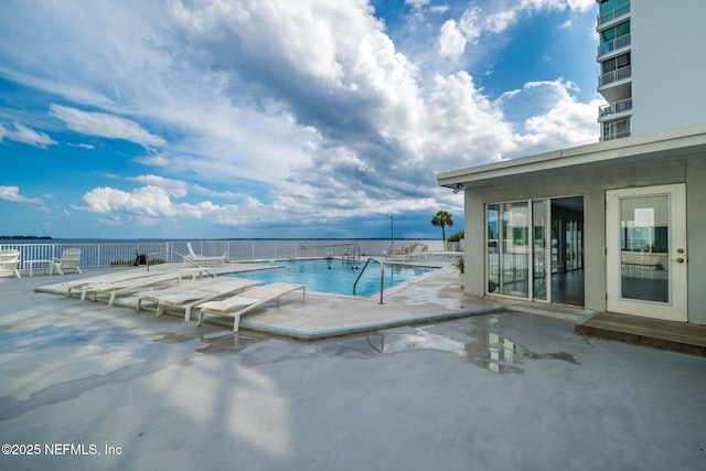 community pool with a patio area