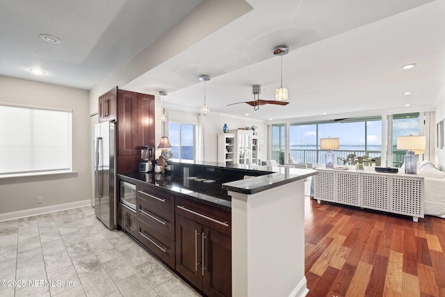 kitchen featuring stainless steel appliances, healthy amount of natural light, a ceiling fan, decorative light fixtures, and recessed lighting