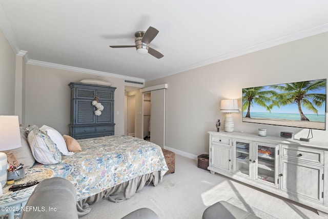 bedroom featuring crown molding, light colored carpet, baseboards, ceiling fan, and a closet