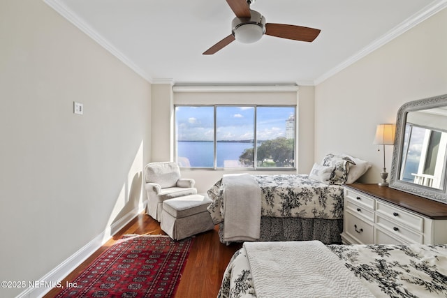 bedroom featuring dark wood-style floors, a water view, crown molding, baseboards, and a ceiling fan