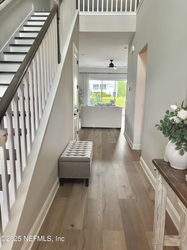627 Rum Runner Way, Saint Johns, FL 32259 - hallway featuring wood-type flooring, stairway, and a high ceiling