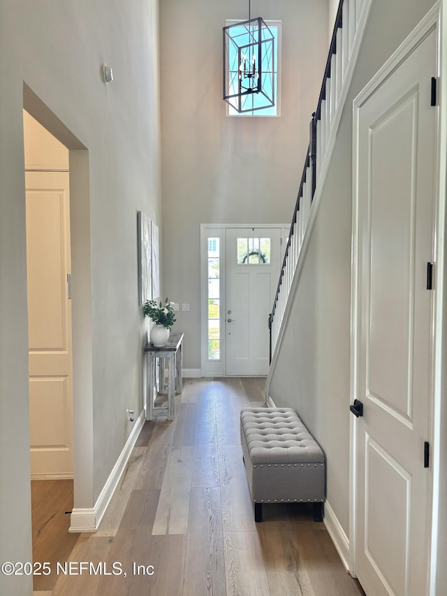 627 Rum Runner Way, Saint Johns, FL 32259 - entryway featuring light wood finished floors, stairway, a towering ceiling, and a chandelier