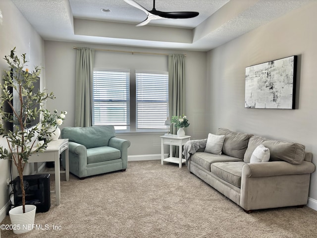 627 Rum Runner Way, Saint Johns, FL 32259 - carpeted living room featuring a ceiling fan, a raised ceiling, and a textured ceiling