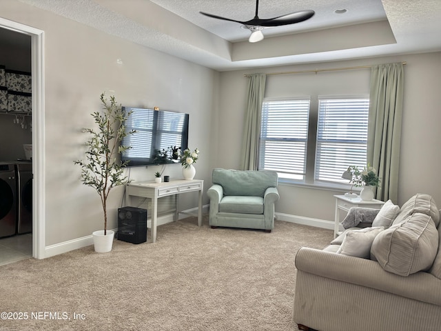 627 Rum Runner Way, Saint Johns, FL 32259 - carpeted living room featuring washer and clothes dryer, a ceiling fan, a tray ceiling, and a textured ceiling